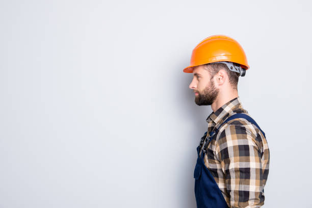 istock Profile portrait with copy space, empty place for advertisement, product of virile harsh repairer in shirt and overall isolated on grey background 970417348