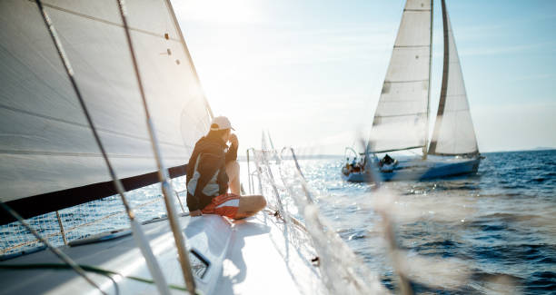 istock Young handsome man relaxing on his sailboat 970417840