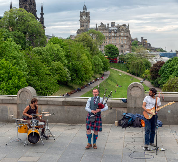 three musicians of band spinning blowfish in edinburgh - scottish music imagens e fotografias de stock