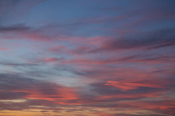 istock pink and orange soft clouds in the air at sunset background 970421120