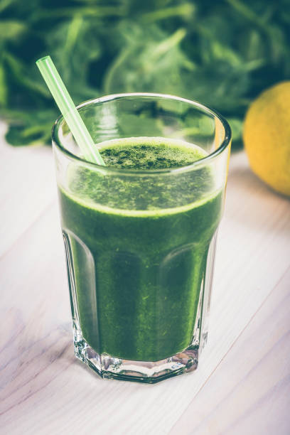 istock Spinach juice with lemon in a soda jug 970421340