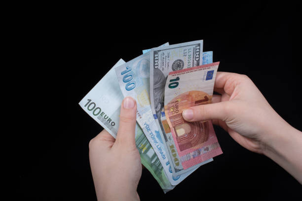istock Hand holding American dollar  isolated on black background 970425432
