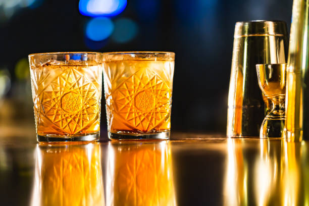 istock Three colorful cocktails in large glasses in a classic bar environment 970436400