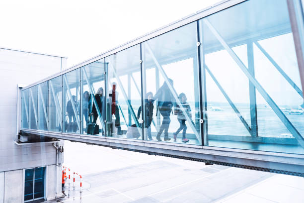 istock Group of people walking trough a glass hallway 970441908