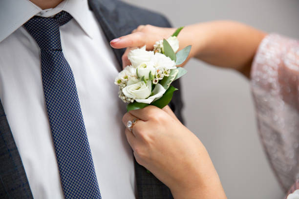 istock Bride fastens groom boutonniere to buttonhole 970444540