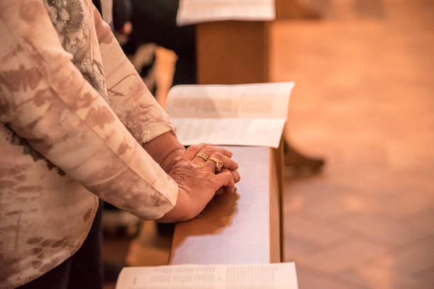 istock Old woman hands praying 970444708