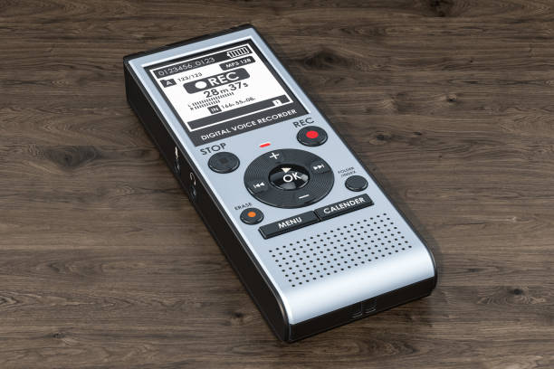 Digital voice recorder, dictaphone on the wooden table. 3D rendering
