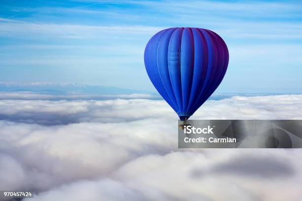 A Lonely Blue Hot Air Balloon Floats Above The Clouds Concept Leader Success Loneliness Victory Stock Photo - Download Image Now