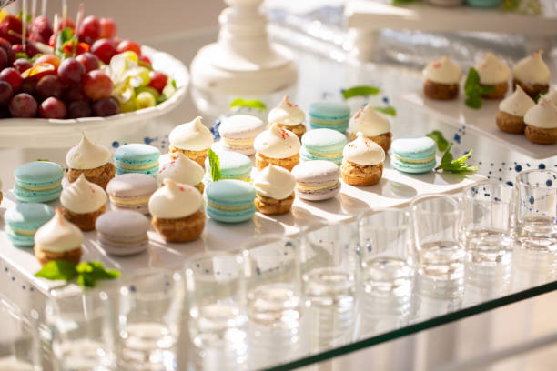 istock delicious macaroons and cupcakes on table at wedding reception. candy bar. tasty colorful sweets for celebrations events and showers. luxury stylish catering 970459928