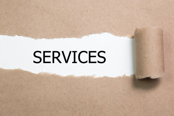 istock The word services appearing behind torn paper 970460064