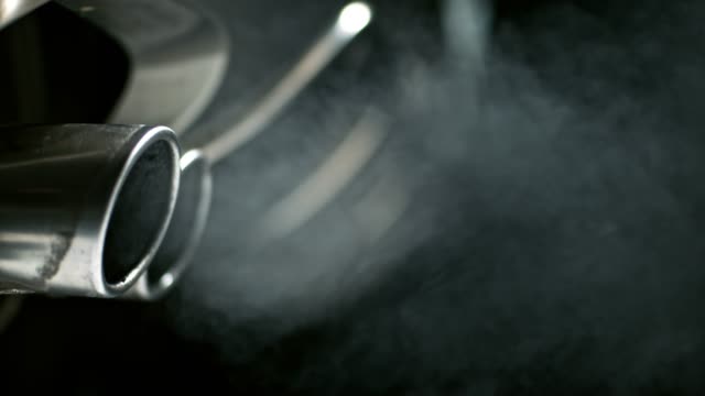 SLO MO Smoke coming from the car exhaust pipes