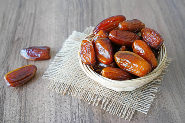 istock Fresh fruit dates in a basket bowl on walnut wooden table 970460430