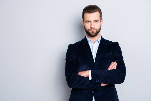 istock Portrait with copy space, empty place for advertisement of elegant attractive teacher with stubble having his arms crossed looking at camera isolated on grey background 970470852