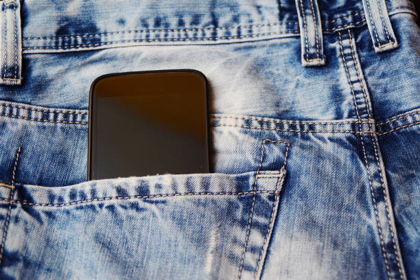 istock Smartphone in back pocket of jeans pants 970471508
