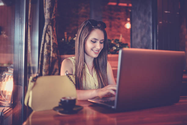 istock Attractive Female Online Shopping While In Coffee Bar 970482520