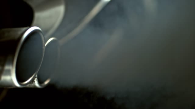 SLO MO Black smoke coming out of the car exhaust