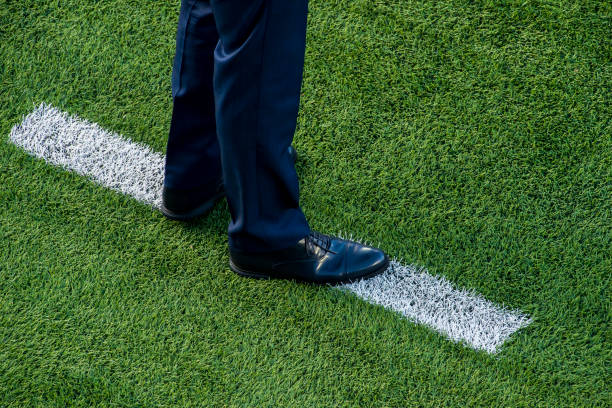 istock Coach standing next to chalk line on soccer field 970490006