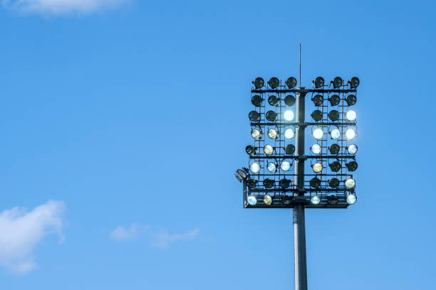 istock spotlight of stadium on blue sky background isolated 970490052
