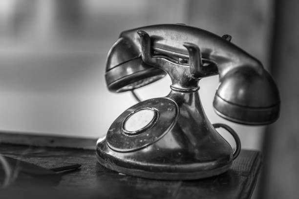 istock Vintage black telephone on old wood desk 970492690