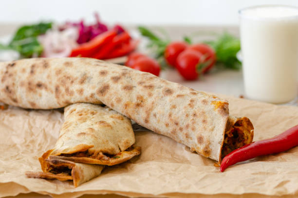 istock Turkish pizza with meat - lahmacun on a wooden table. 970498662