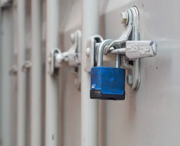 A padlock secured a white storage shipping container