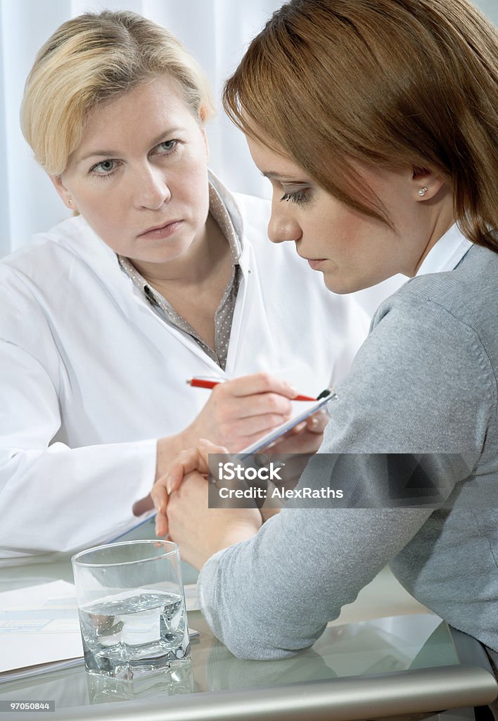 Two women having a conversation young woman in a conversation with a consultant or psychologist. Adult Stock Photo