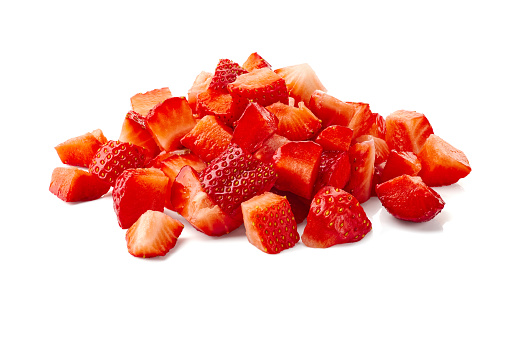 Heap of ripe chopped strawberries isolated on white background