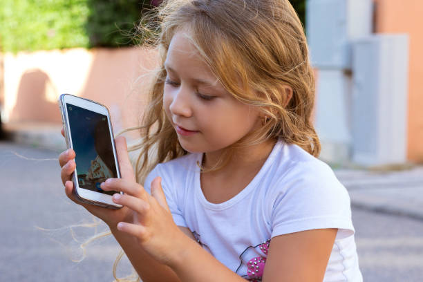 istock Content little girl showing smartphone 970509840