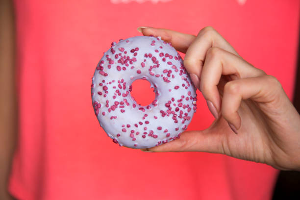 istock Female hand hold tasty donut 970517108