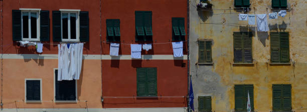 istock Italian building facade with green shutters and clotheslines. 970524554