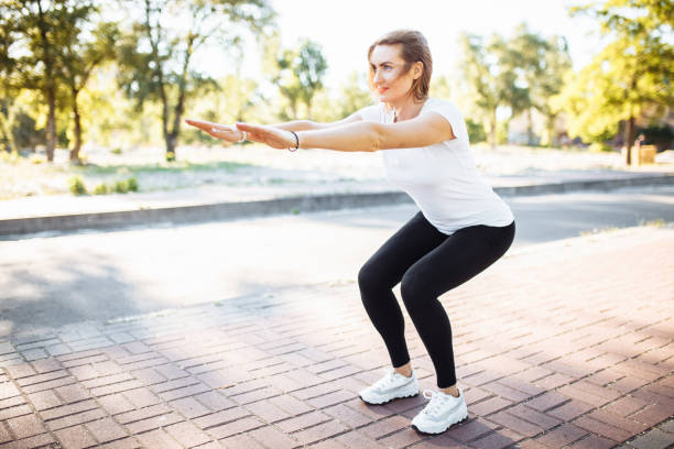 istock Young athletic girl, performs squats, can be used for advertising, text insertion 970524932