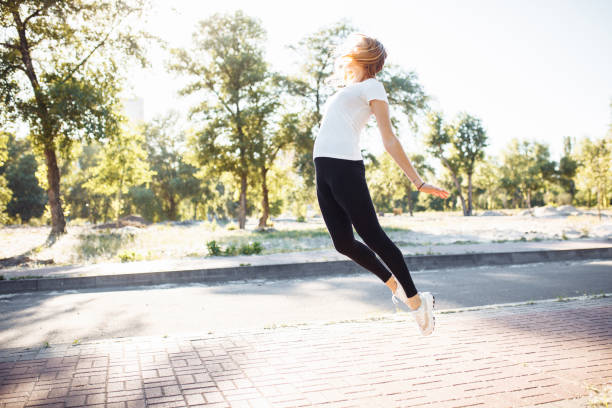 istock young athletic girl doing exercise, posing in a jump, can be used for advertising, text insertion 970526424