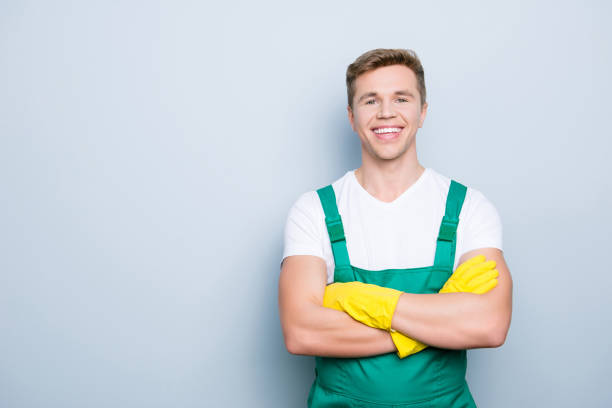 istock Portrait of friendly confident polite hard-working professional successful handsome with toothy beaming smile janitor wearing white tshirt standing with folded arms isolated gray background copy-space 970542490