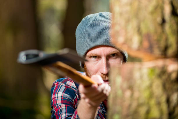 istock hipster woodcutter chopping wood, focus on eyes 970542820