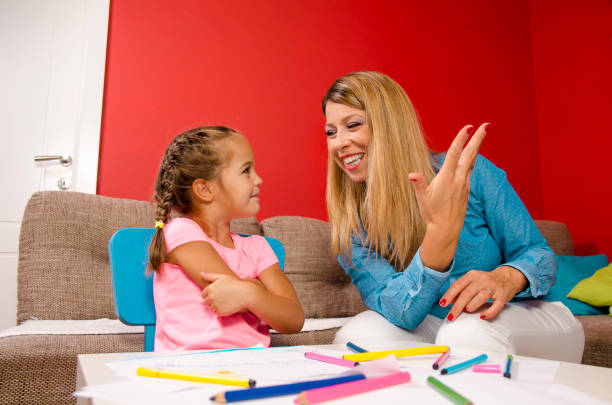 istock Mother tutoring her little child, learning math 970550498