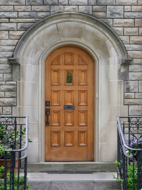 istock wooden door with stone frame 970553590
