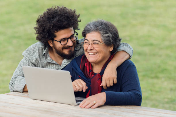 istock Senior woman and son using laptop 970556652