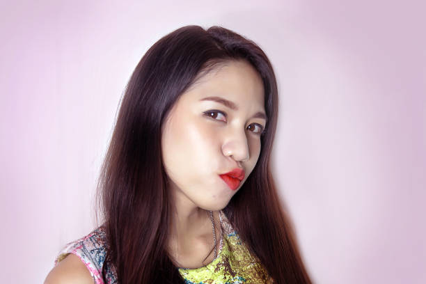 istock cute asian lady smile with pink lipstick on studio shot. 970559840