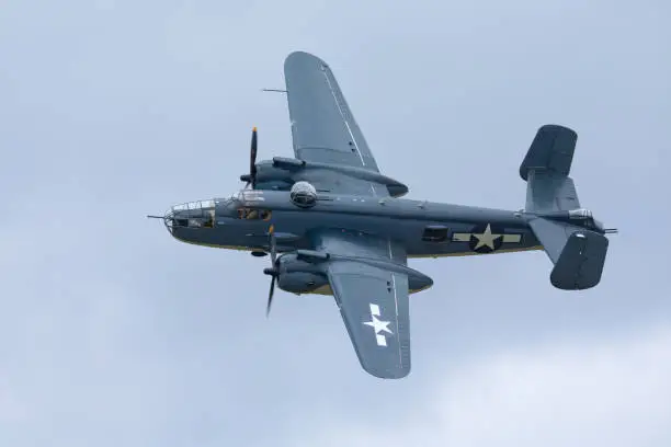 WWII bomber (B-25J Mitchell) against a cloudy sky