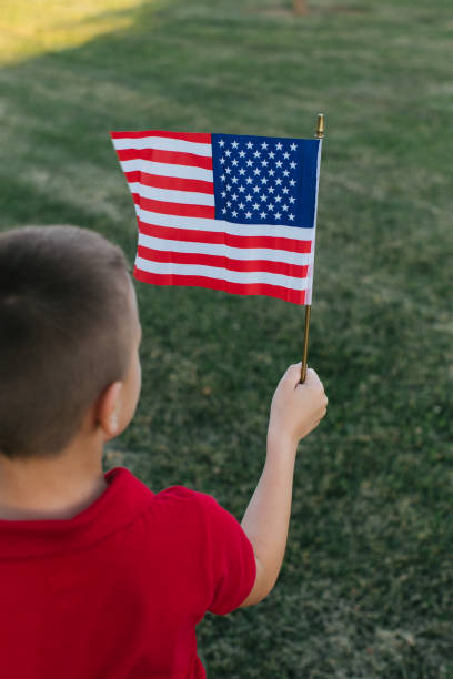 istock Boy holding American flags in his hand 970589740