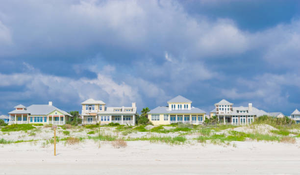 Vacation Beach Houses in St. Augustine, Florida A row of vacation cottages in the sand dunes in St. Augustine, Florida. pretty beach house stock pictures, royalty-free photos & images