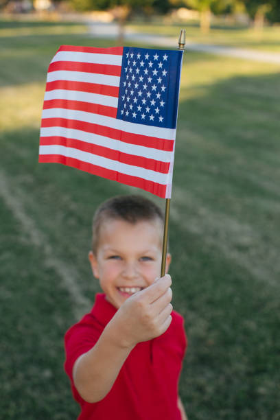istock Young boy waving small american flag 970589930