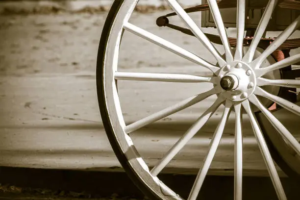 Wooden wheel of a horse drawn carriage.