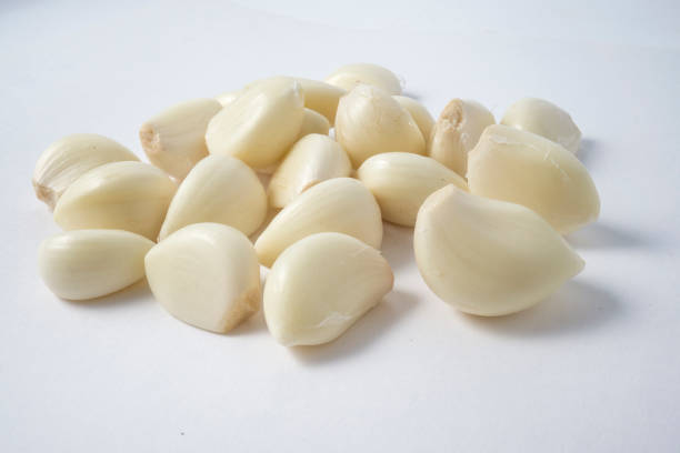 istock Garlic cloves close up isolated on the white background 970595984