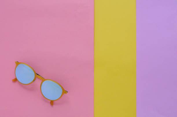 istock Yellow sunglasses on colorful background for summer time. 970596160