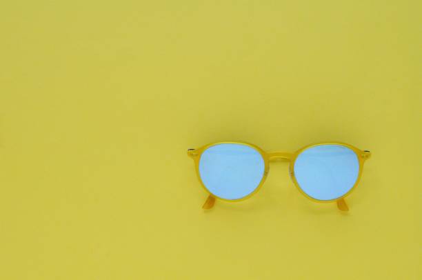 istock Yellow sunglasses on yellow color background for summer time. 970596166