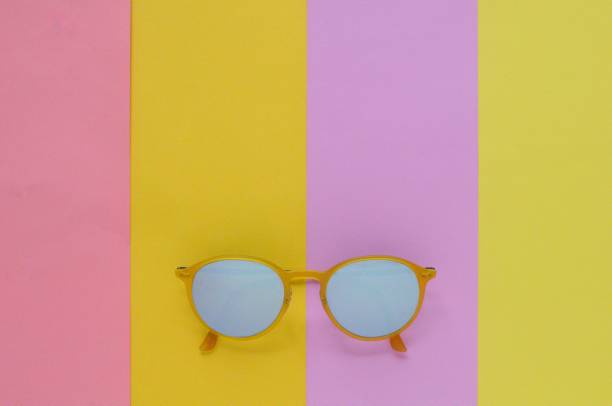 istock Yellow sunglasses on colorful background for summer time. 970596202