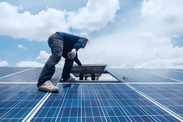 Photo of engineer team working on replacement solar panel in solar power plant;engineer and electrician team swapping and install solar panel ; electrician team checking hot spot on break panel