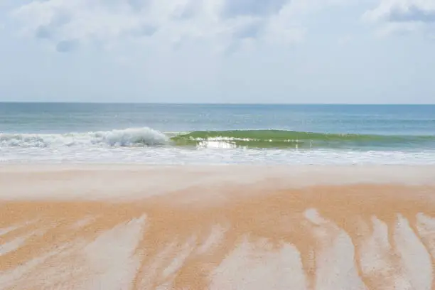 An orange sandy beach with textured pattern near St. Augustine, Florida.