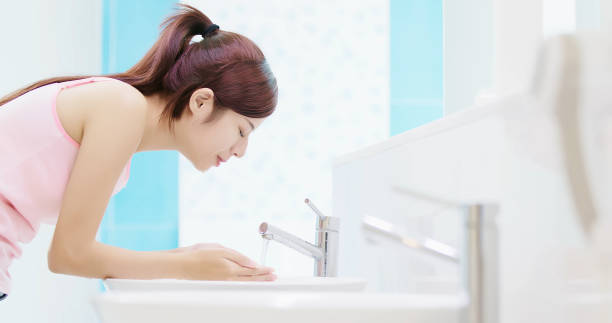 istock woman wash her face 970617432